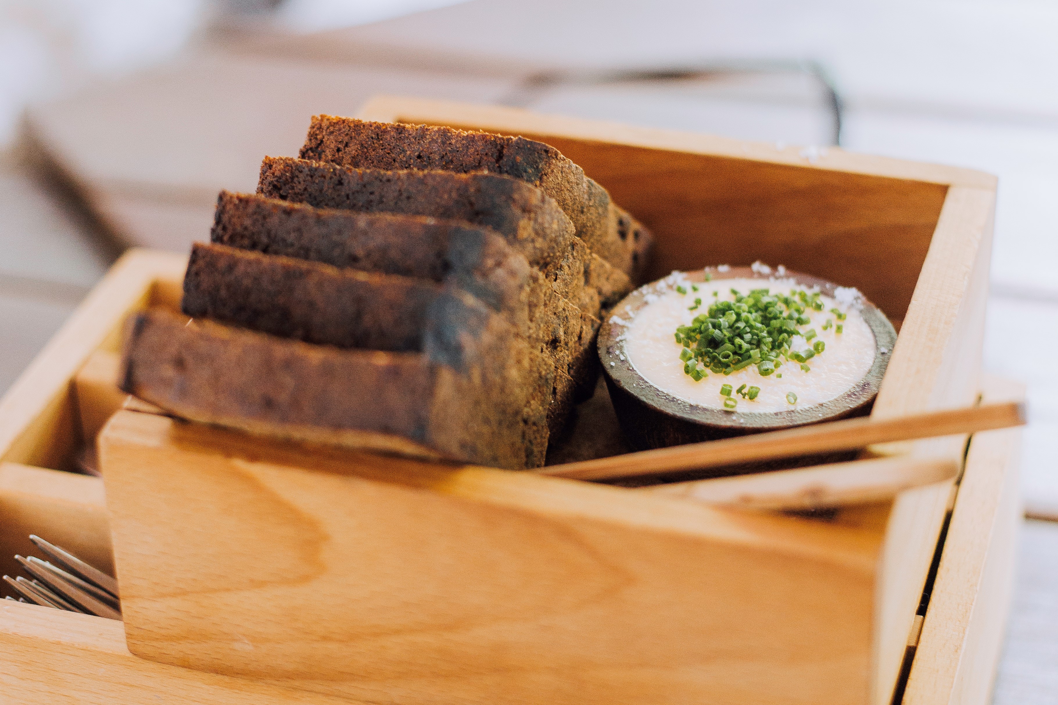 Freshly baked Estonian black bread with herb butter in Leib, a restaurant in Tallinn, Estonia. 