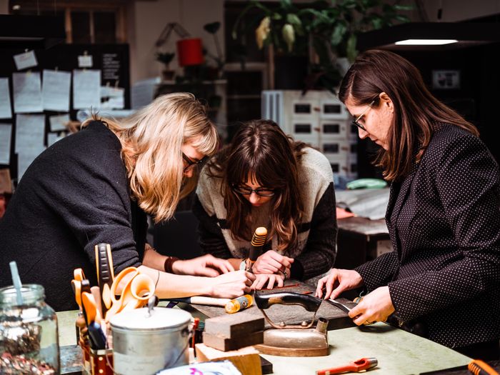 People crafting with leather at the Stella Soomlais leather workshop. Photo by: Kadi-Liis Koppel 