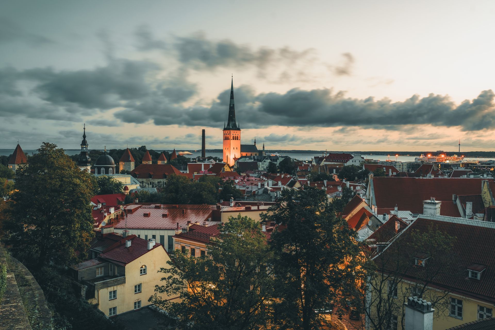 Evening view of the rooftops of Tallinn's Old Town and the tower of St. Olaf's Church in Estonia.

