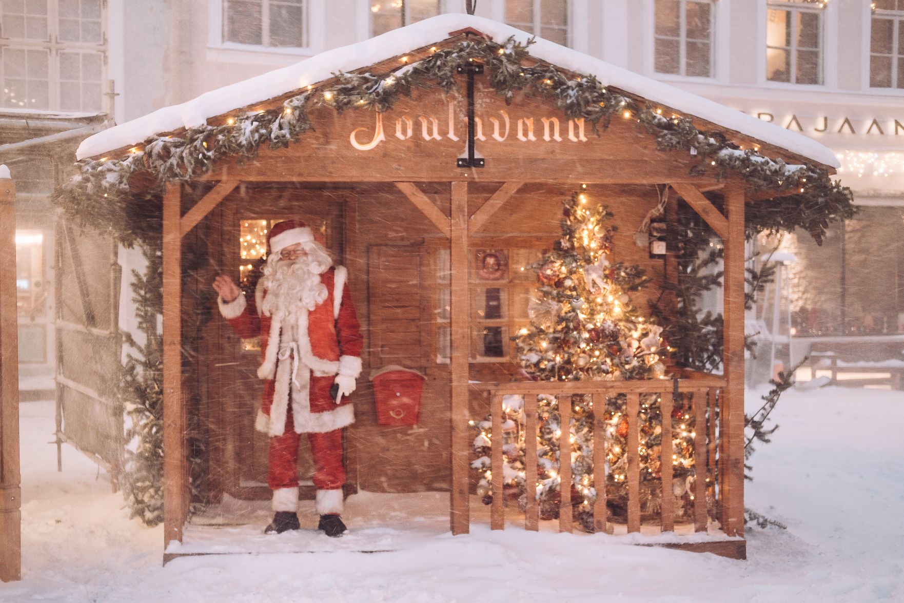 Santa Claus waving in front of his house at Tallinn Christmas Market.