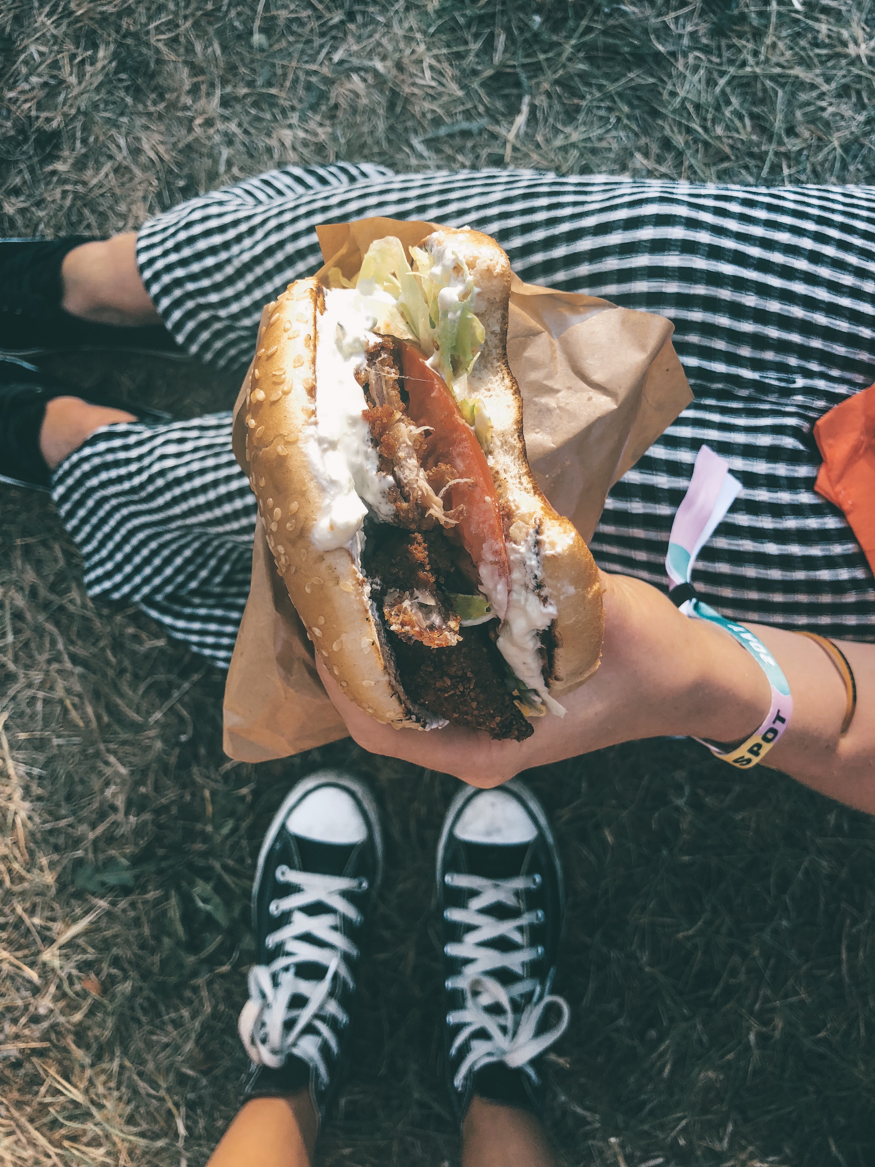 Girl eating a burger at an outdoor music festival in Tallinn, Estonia