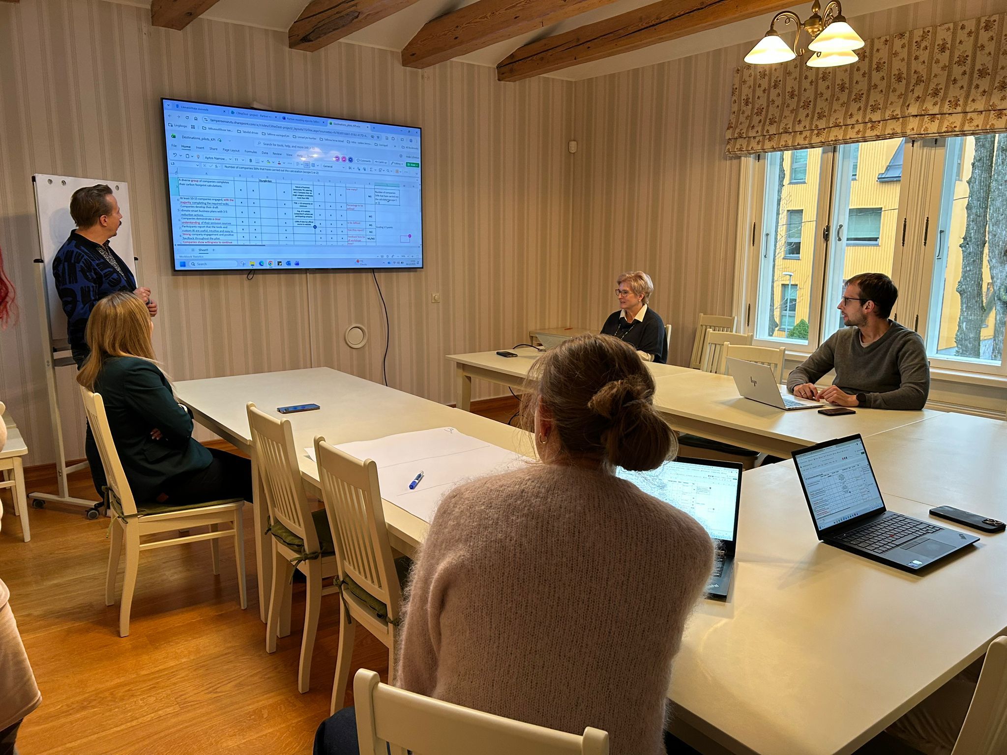 CliNeDest töökoosolek Tallinnas CliNeDest projekti töökoosolek Tallinnas, osalejad istuvad laua ümber sülearvutitega ja jälgivad ekraanil olevat tööplaani.