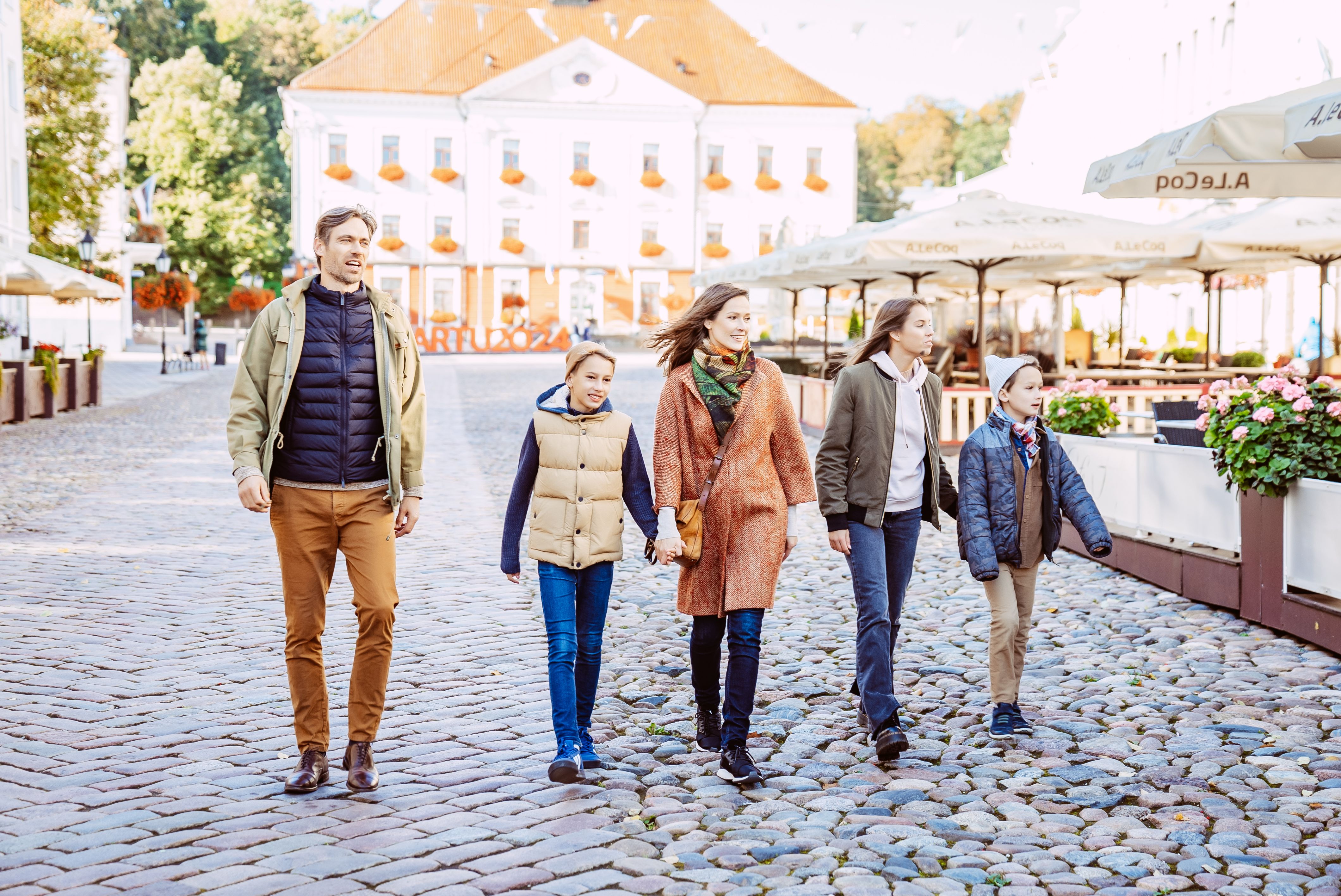 Family of five walking in Tartu Old Town in the autumn.