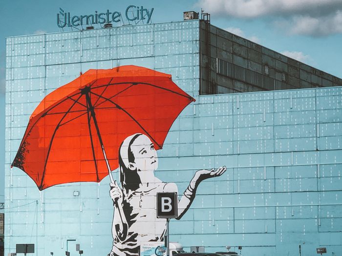 A giant mural of a girl with a read umbrella on a wall in Ülemiste City in Tallinn, Estonia Photo: Maret Põldveer-Turay